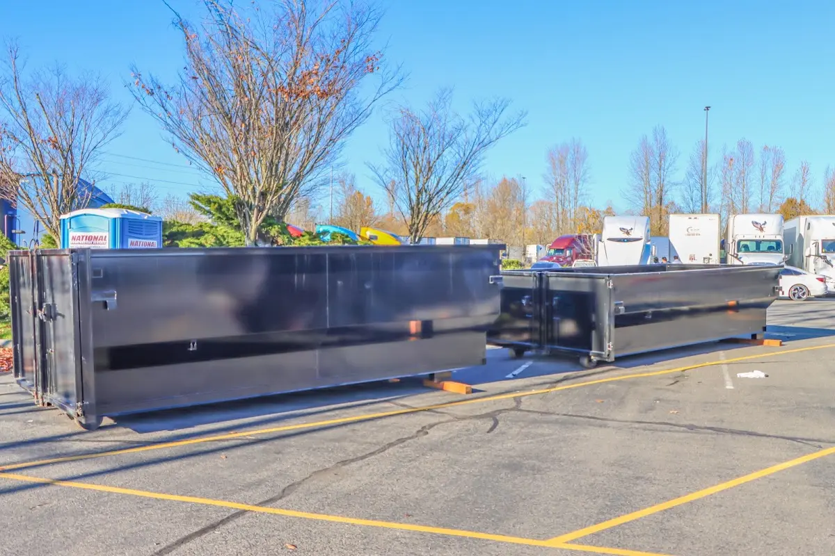 Professional dumpster rental service with roll-off container on residential driveway in Port Townsend